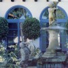 Statues and a fountain in the garden area of Castillo Del Lago