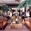 Large potted tropical plants used as décor within a large luxury boutique