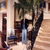 A large potted tropical plant used as décor near the staircase inside a luxury boutique  
